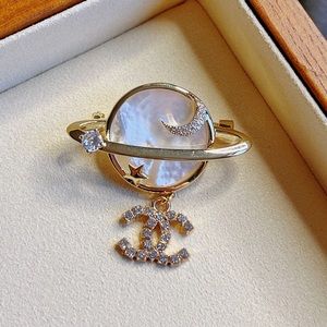 Chanel moon and star planet brooch with crystal charm